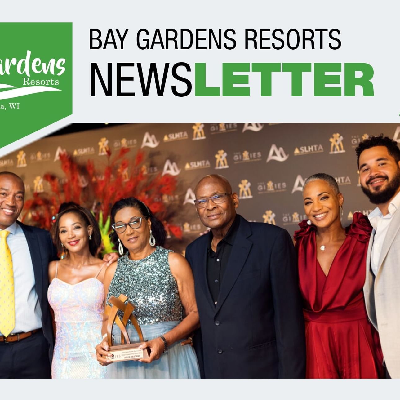 Hotel management poses at an award event, background used in a banner titled 'Newsletter' at Bay Gardens Hotels and Resorts