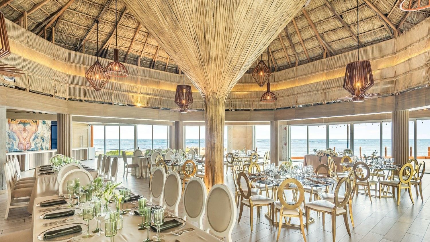 Elegantly decorated banquet hall with large windows and ocean view at Grand Fiesta Americana Veracruz.