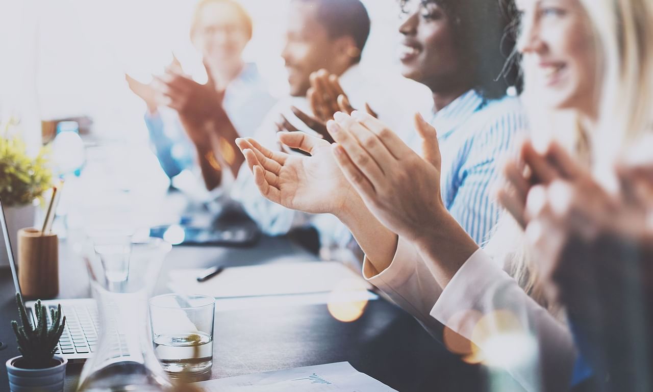 People clapping during business meeting