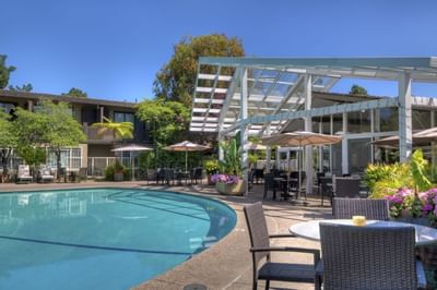 outdoor pool on sunny day and seating area