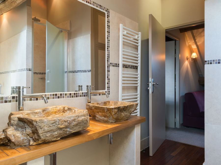 Bathroom vanity in bedrooms at Hotel Aux Vieux Remparts