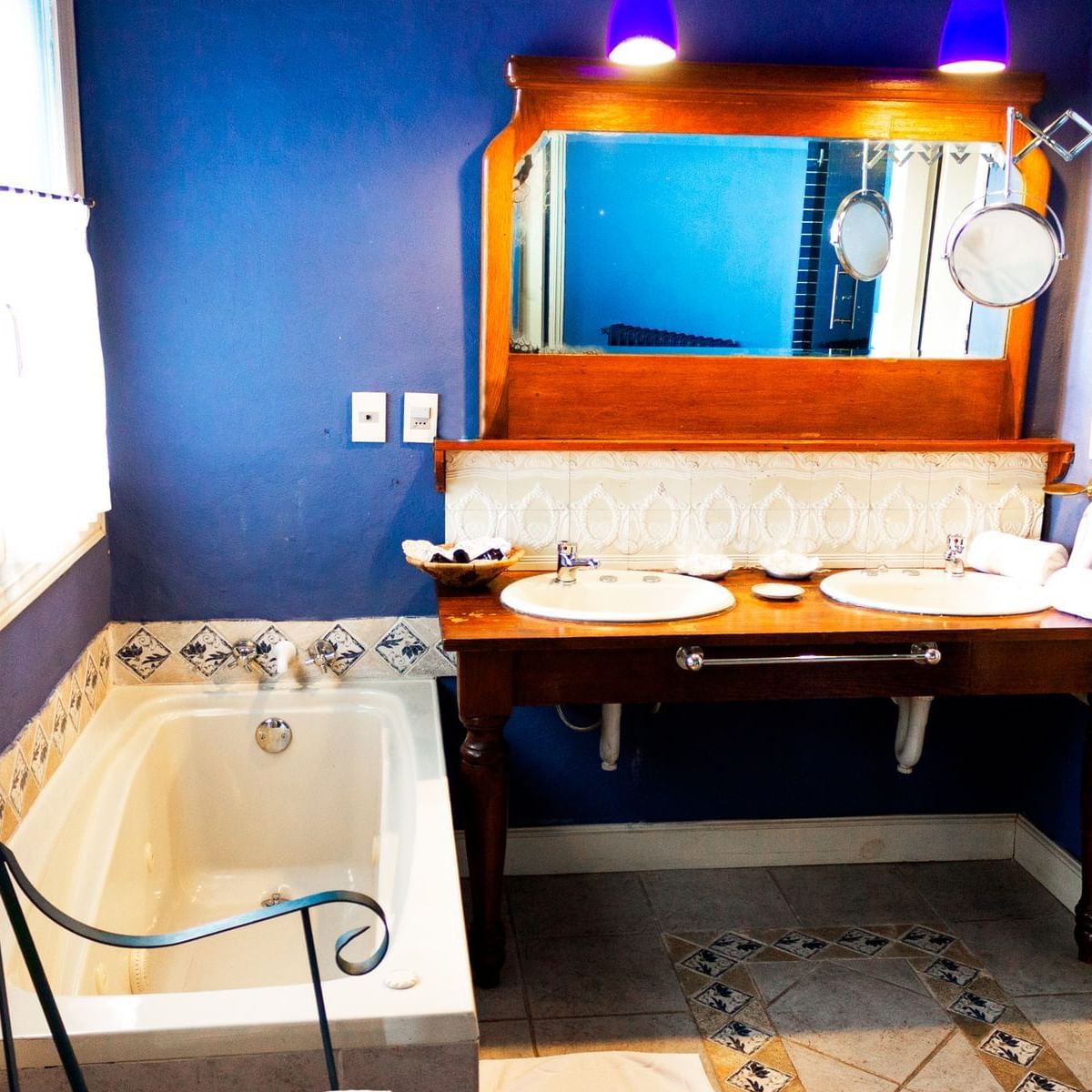 The Suite bathroom with double sinks & bathtub at DOT Hotels