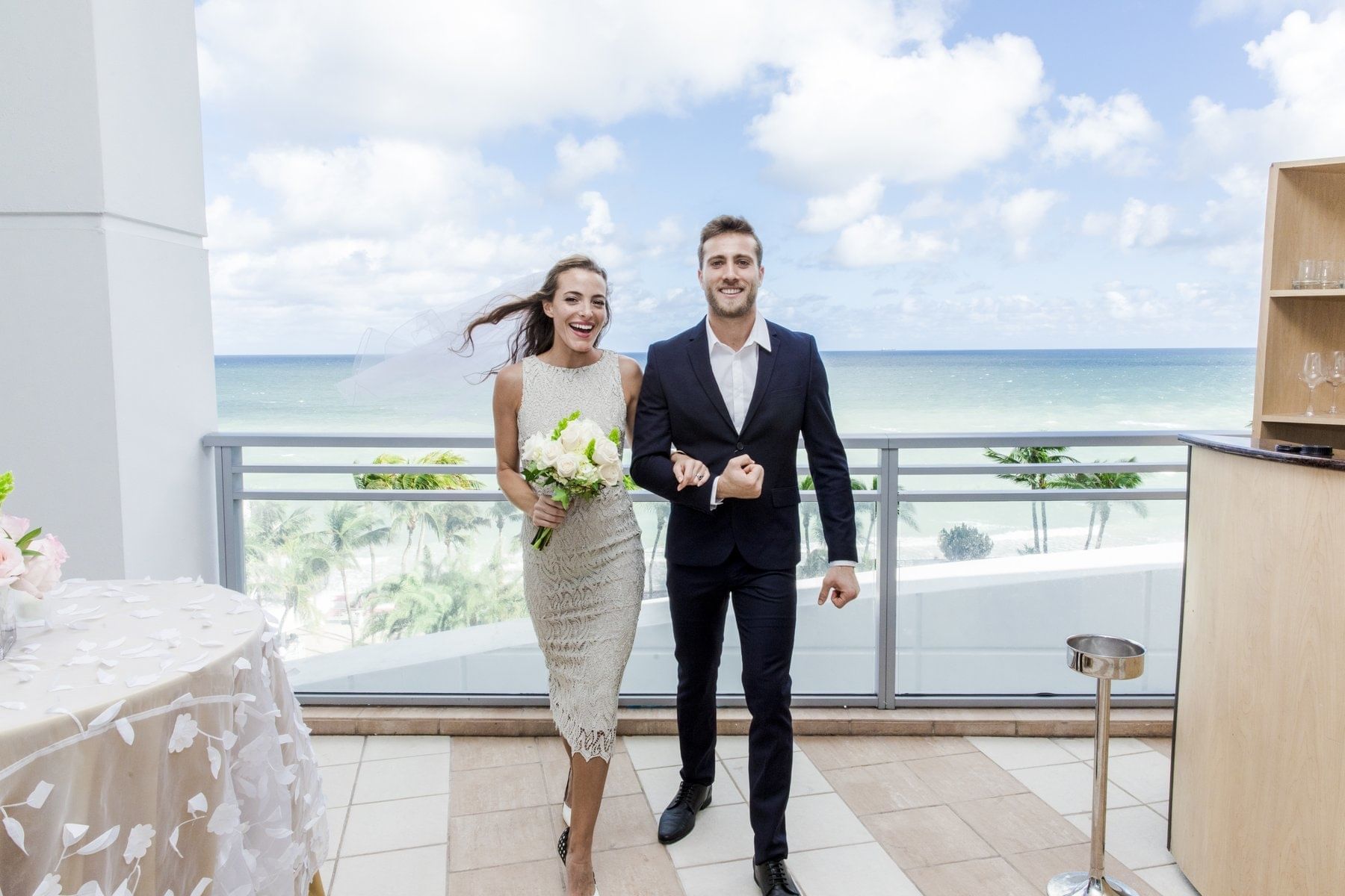 Bride & Groom posing on the balcony at The Diplomat Resort
