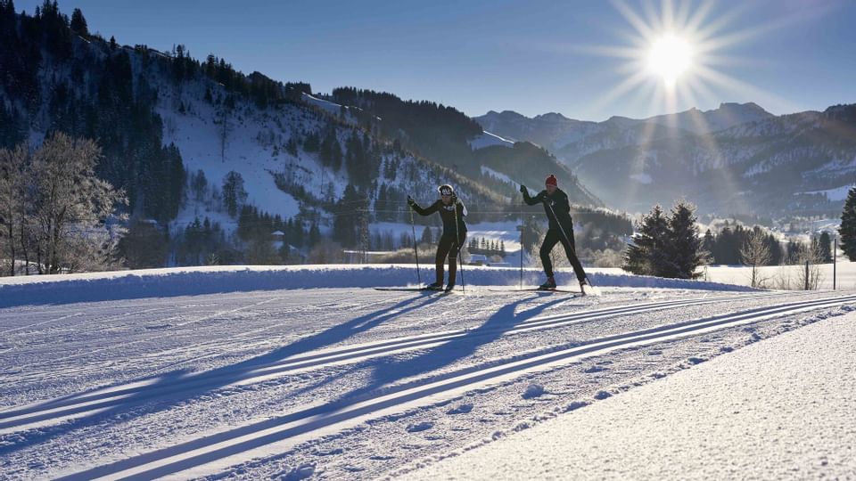 Two skiers while cross-country skiing near Liebes Rot Flueh