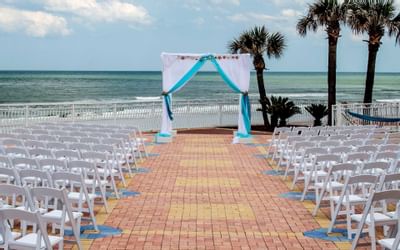 tables and chairs set for wedding on outdoor terrace