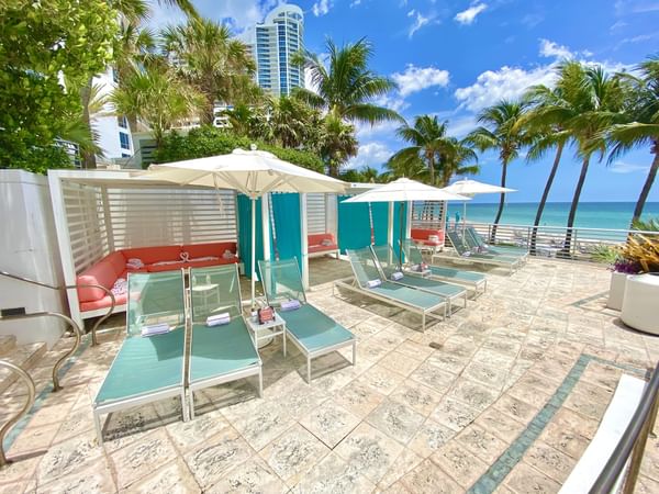 Sunbeds by the pool with a Beach view at The Diplomat Resort