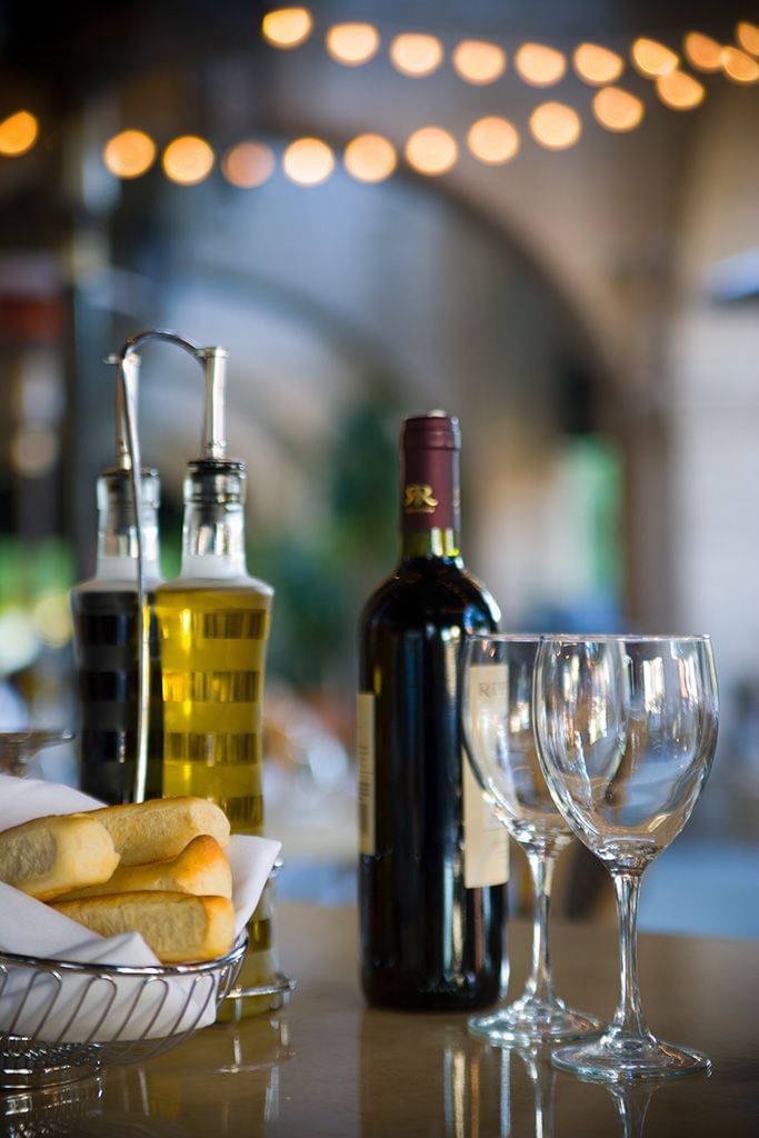 table with wine glasses and bread sticks