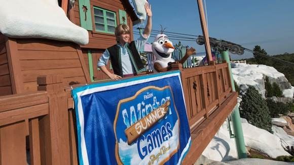 Person waving next to an Olaf character statue near Lake Buena Vista Resort Village & Spa