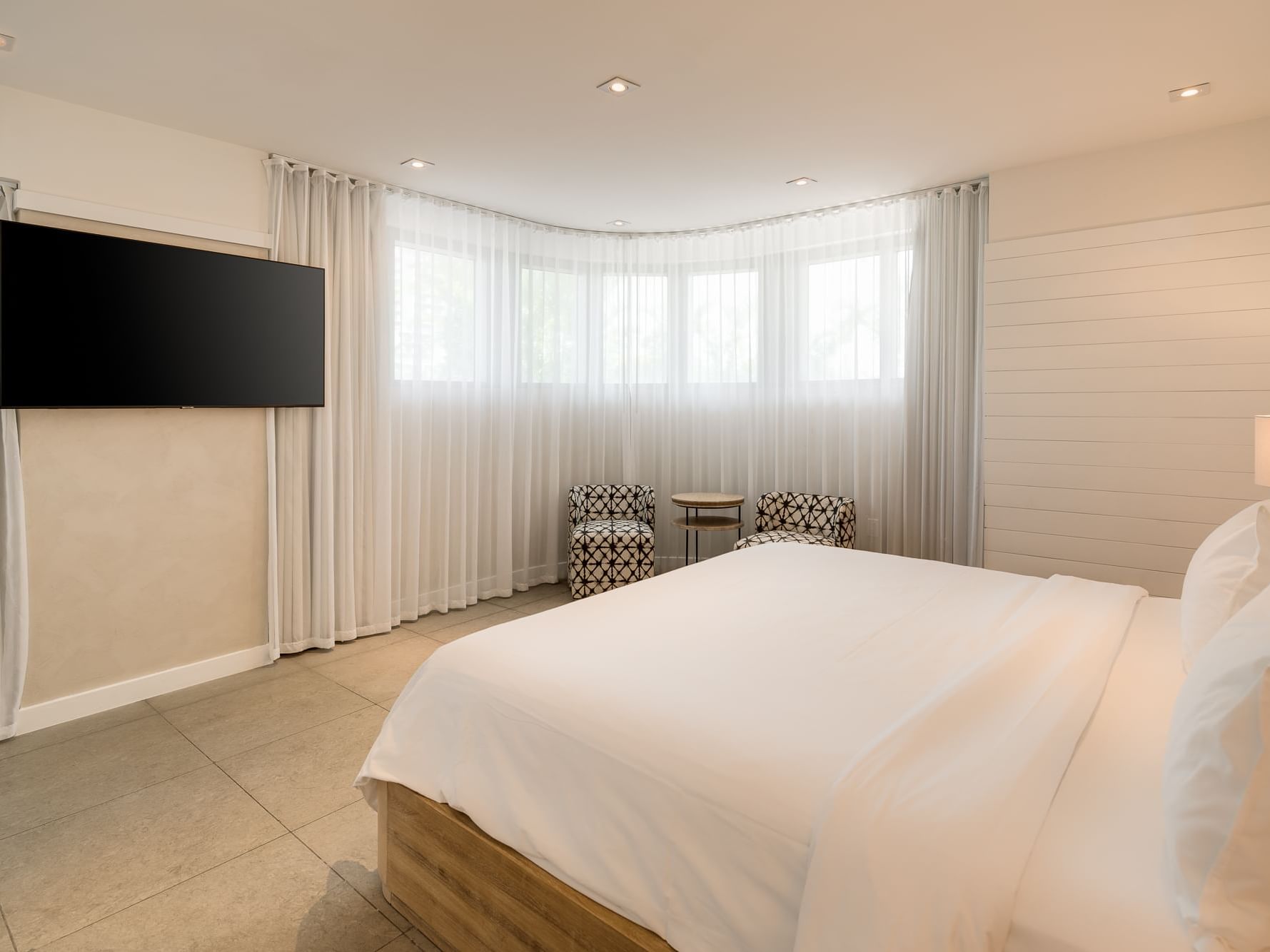 Bedroom with two chairs in King Studio at Boulan South Beach