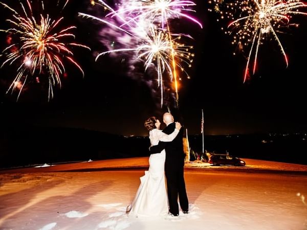 bride and groom under fireworks