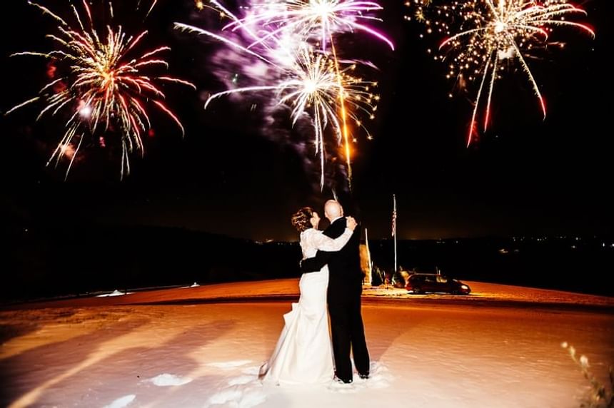 bride and groom under fireworks