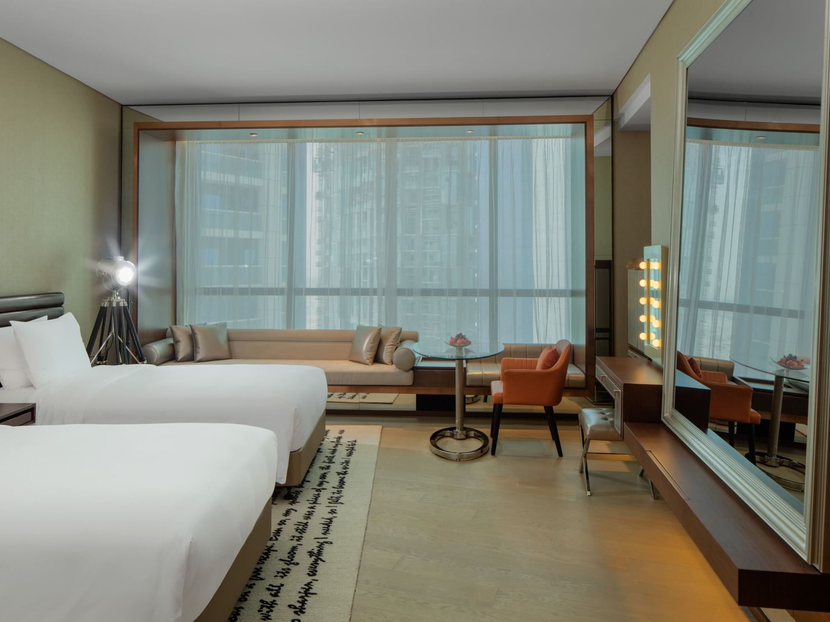 Two beds and seating area in Scene Room - Downtown View at Paramount Hotel Dubai