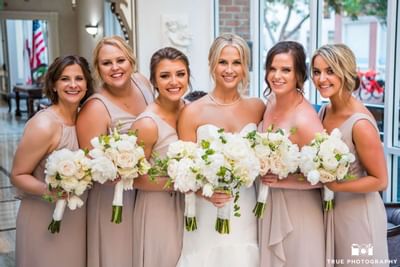 Bridal party holding flower bouquets at Horton Grand Hotel