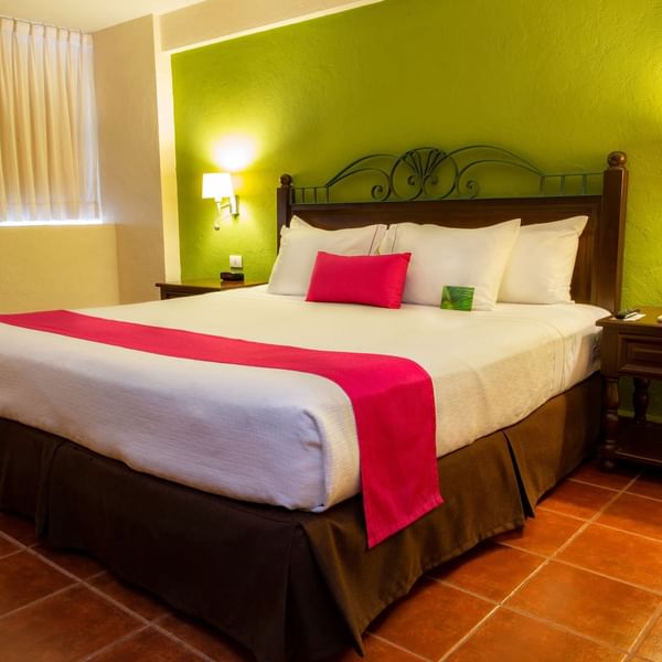 King bed in Superior King Room at Gamma Hotels