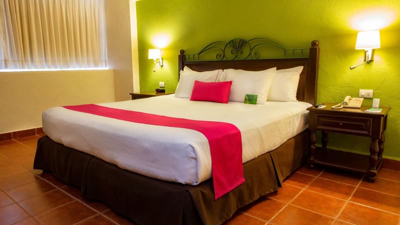 Interior of a room with a king bed at Gamma Mérida el Castellan