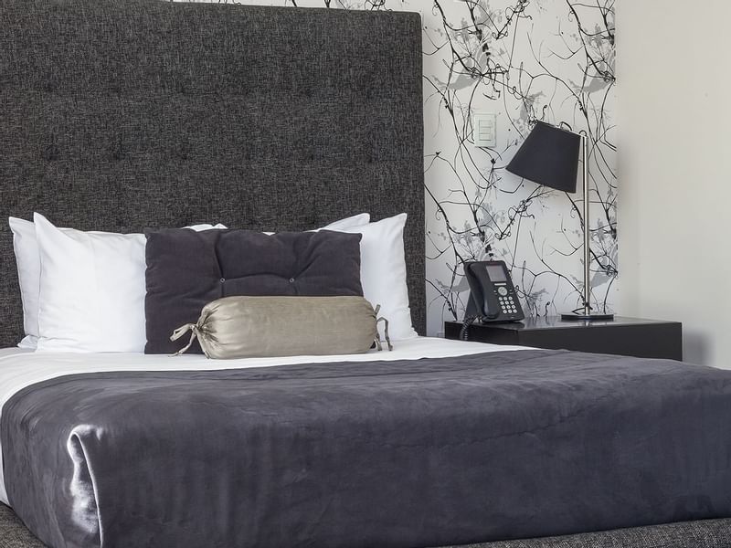 Bed, telephone & lamp in the Superior Room at Gamma Hotels