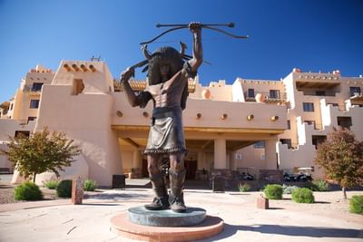 Statue of a Native American warrior  at Hilton Santa Fe Buffalo Thunder, set against a clear blue sky