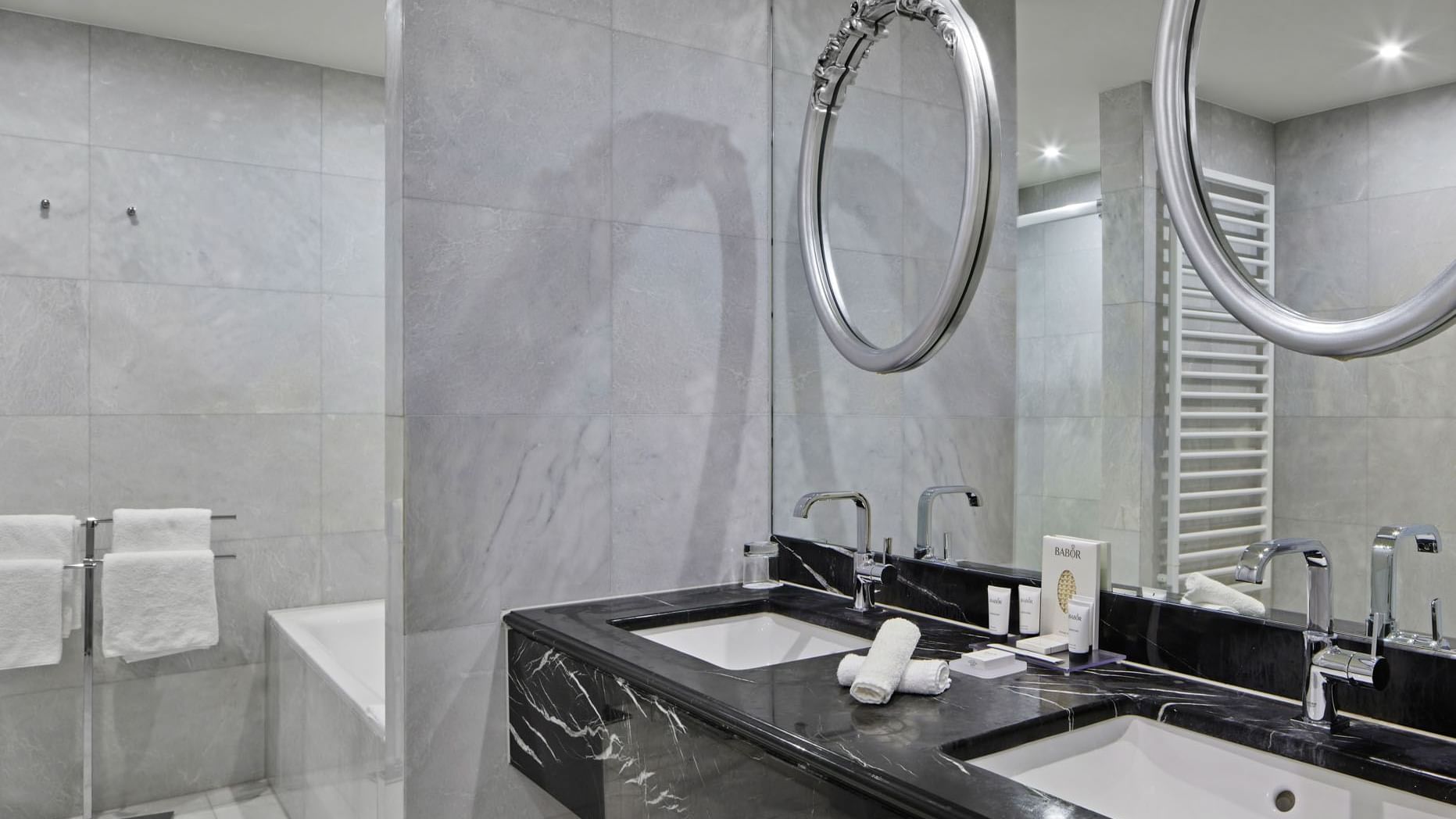 Bathroom with vanity & bathtub in Gendarmenmarkt Duplex Suite at Titanic Gendarmenmarkt Berlin