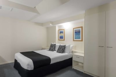 Double bed with cushions in Studio Apartment at Nesuto Hotels