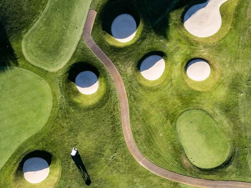 High-angle view of a golf course near Falkensteiner Hotels