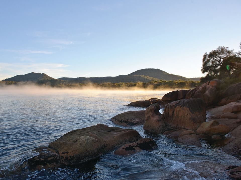 East Coast Cruises beach with large rocks near Freycinet Lodge