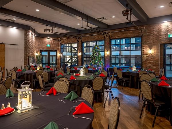 Round tables set for an event in a meeting room.