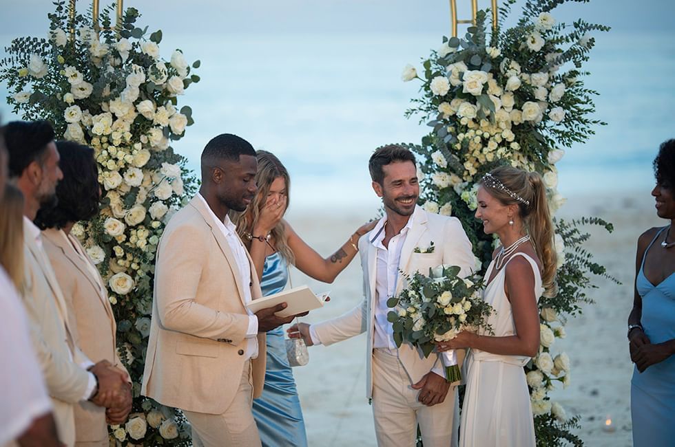 Wedding ceremony with a couple holding hands in beach near Live Aqua Resorts and Residence Club