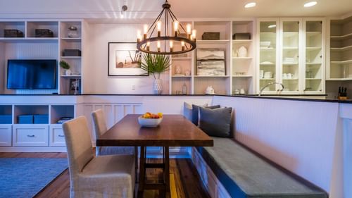Dining area arrangement with a chandelier in Premium Resort suite at Watersound Inn