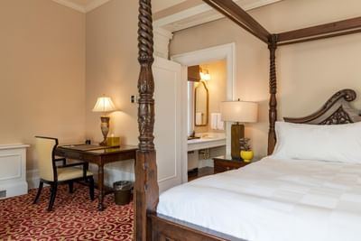 Bed with working desk in hotel room at Castle Hotel and Spa
