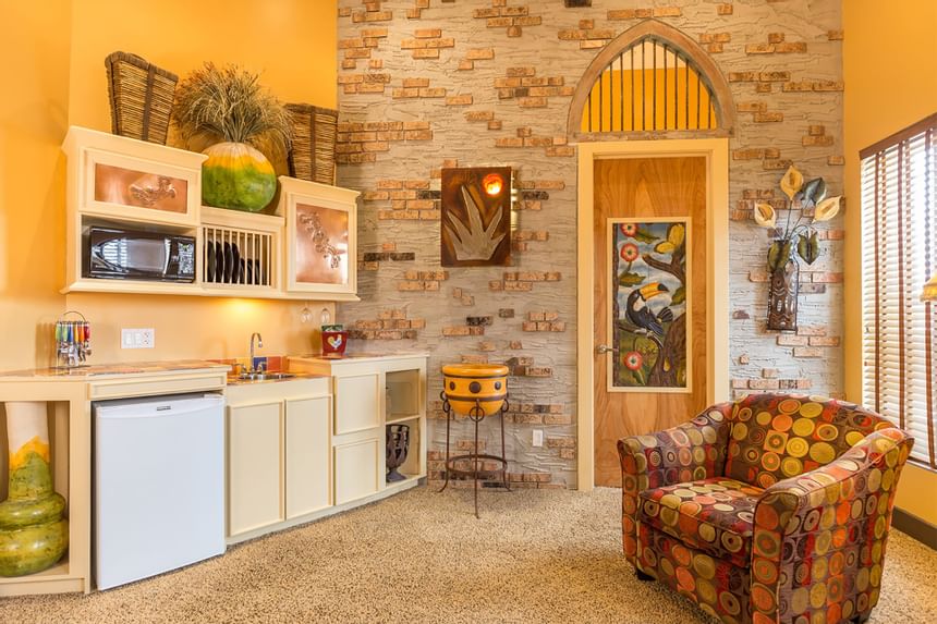 Kitchen area with appliances & brick wall decor in King Premiere Sante Fe at Retro Suites Hotel