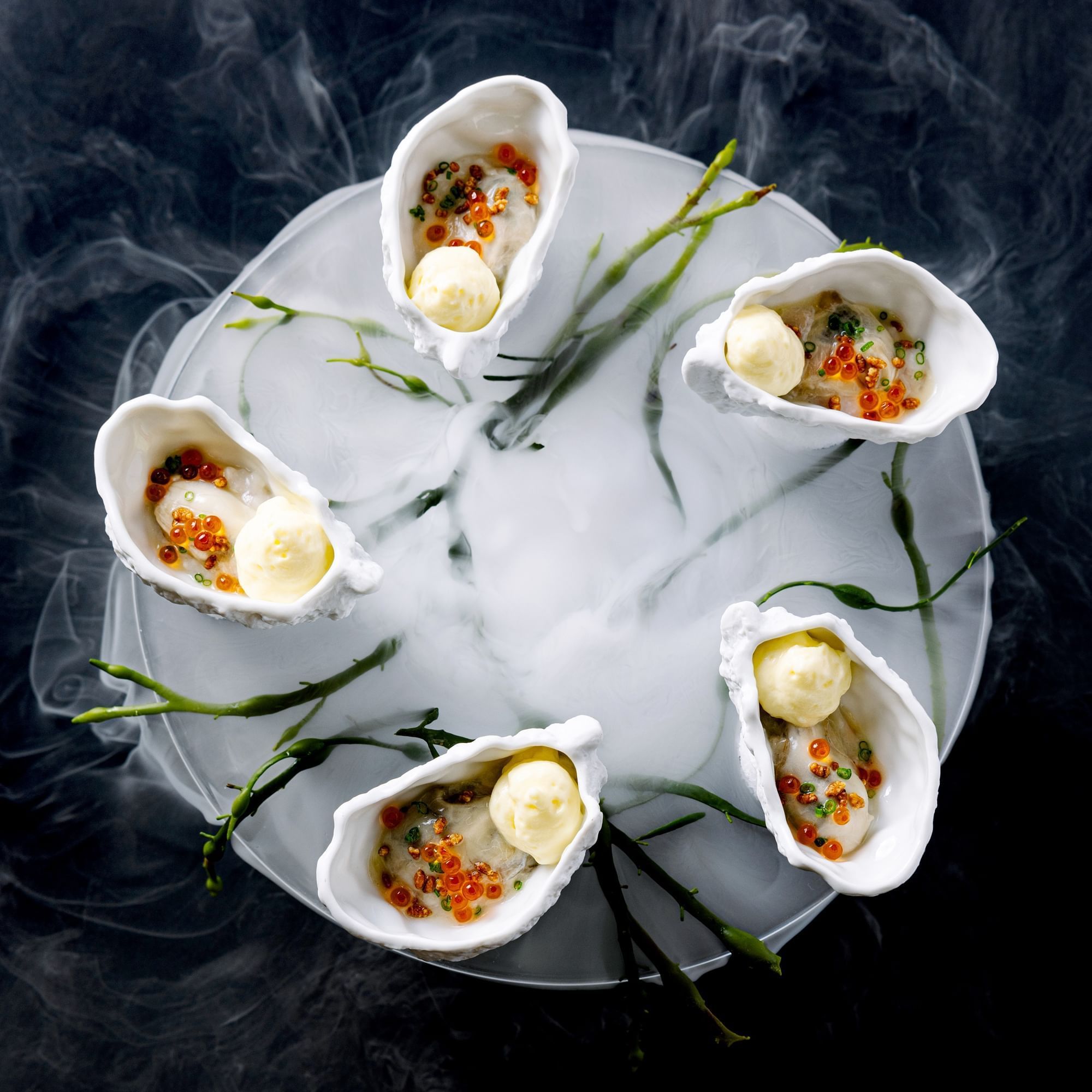 Close-up of oyster inspired dish with smoke served in Herons at The Umstead Hotel and Spa