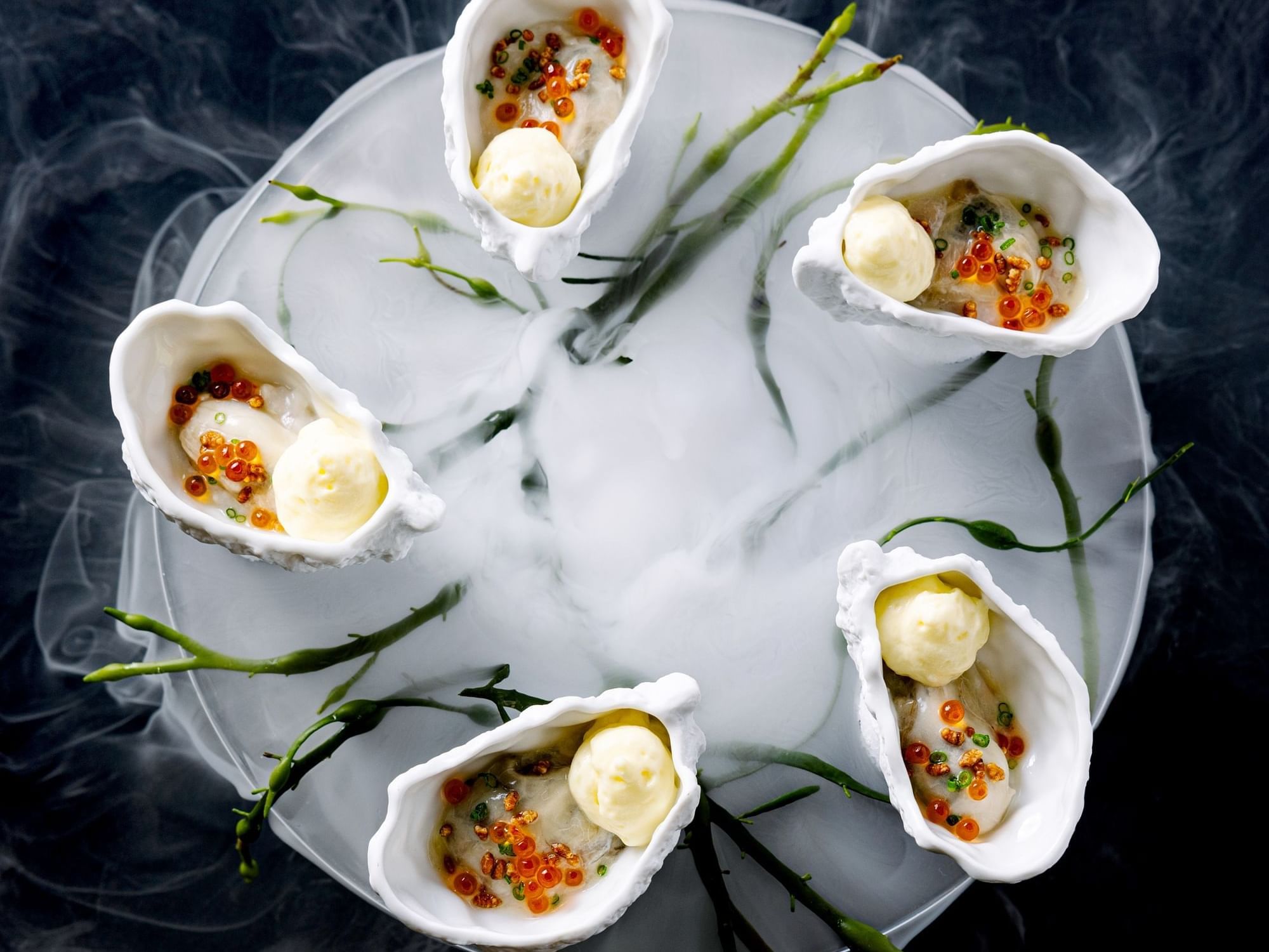 Close-up of oyster inspired dish with smoke served in Herons at The Umstead Hotel and Spa