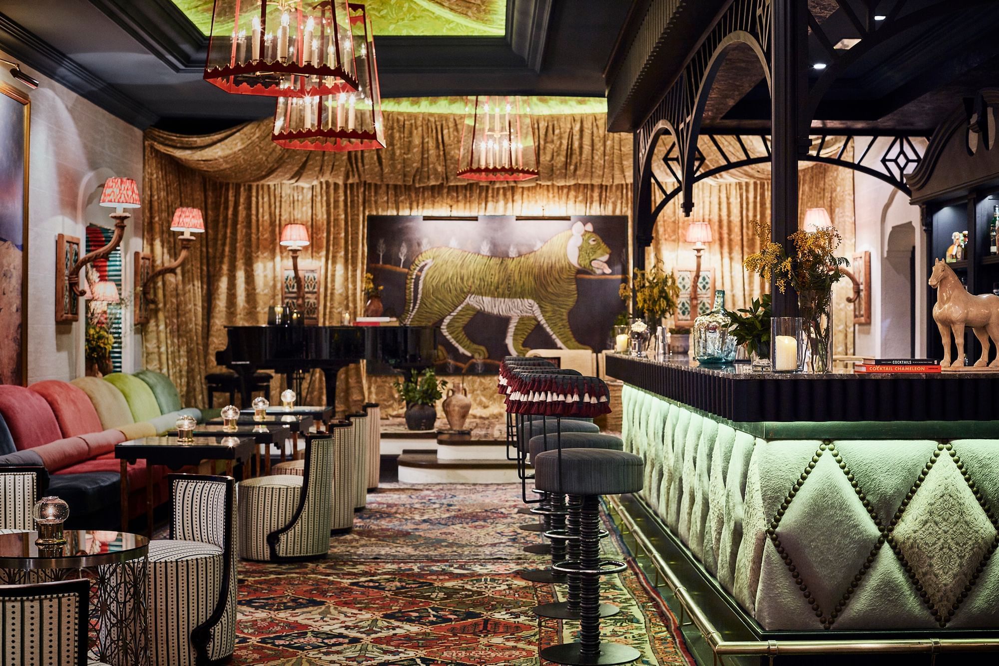 Opulent Marbella Club bar with a grand piano, plush seating, and a bold tiger artwork