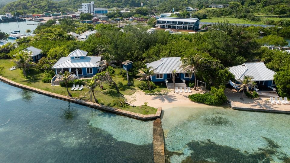 Aerial view of bungalows with beach and marina at Roatan dive resorts, Barefoot Cay Resort & Marina
