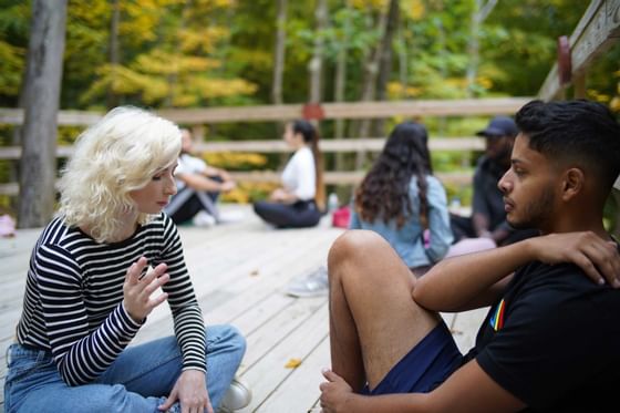 People sitting & discussing in a park near Honor’s Haven Retreat