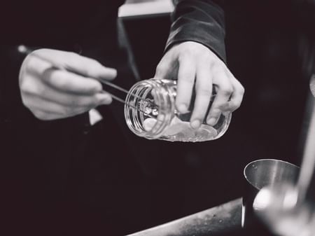 Barman filling a jar with ice at Warwick Paris Champs Elysées