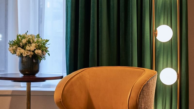 Bouquet of white flowers & light decor by a lounge in Deluxe at The Capital Hotel London