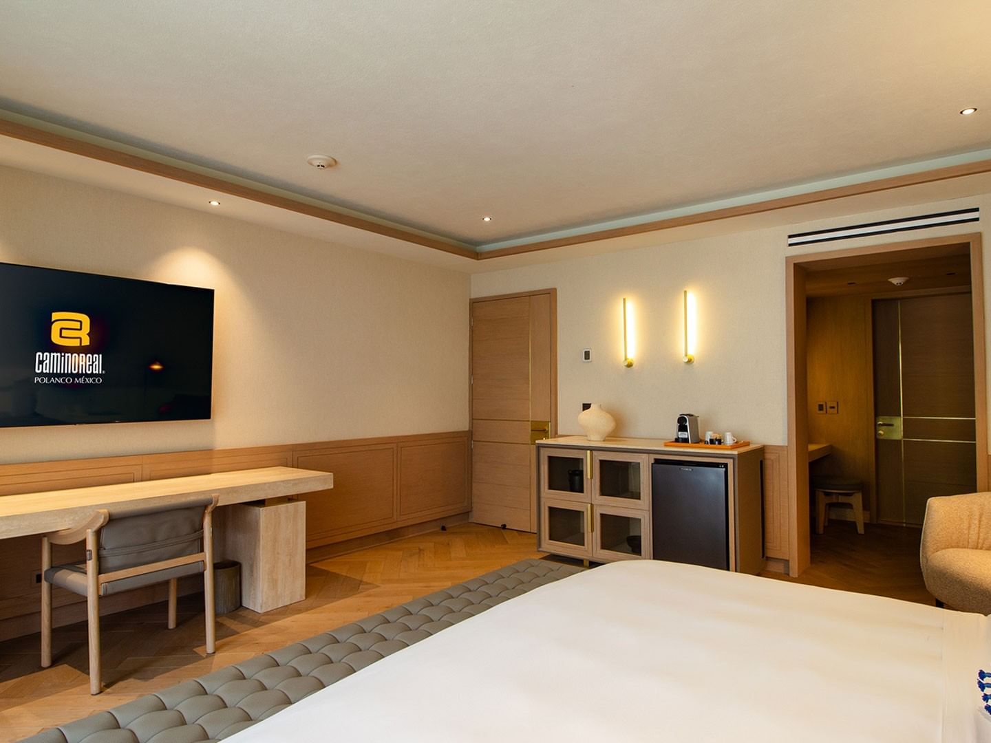 King Superior Viceroys Suite with light wood panels, a work desk, and hardwood parquet floors at Camino Real Polanco Mexico