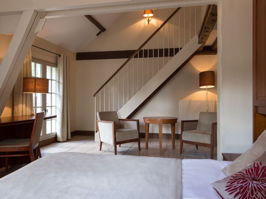 A Living room with the staircase at Hotel Aux Vieux Remparts