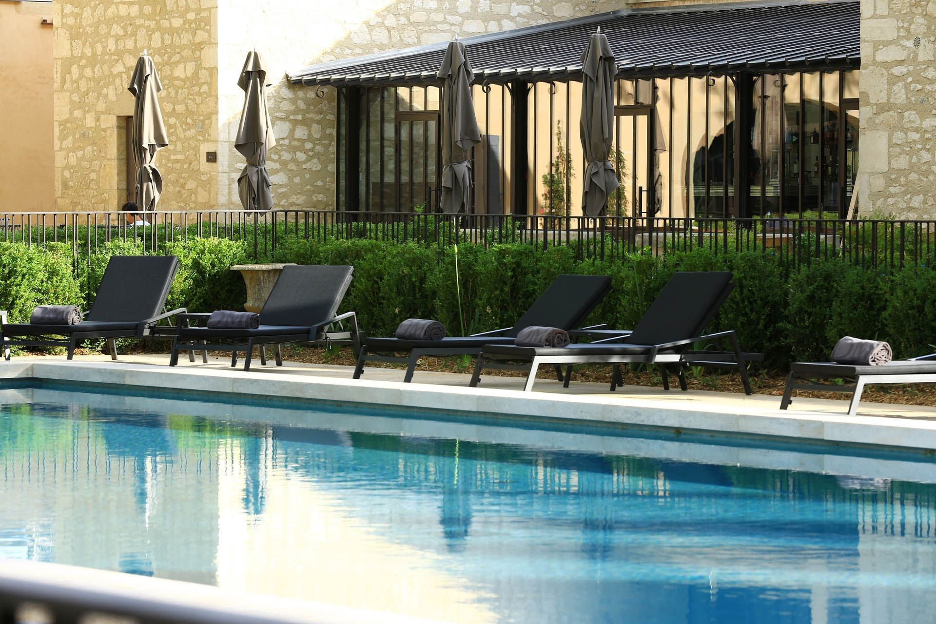 Outdoor pool with pool beds at Domaine de Manville
