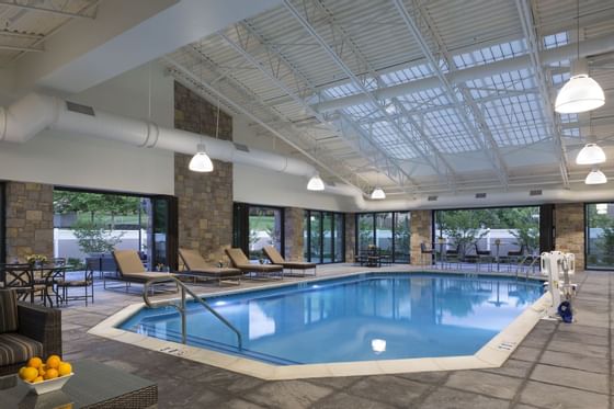 indoor pool with lounge chairs