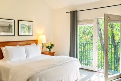King Deluxe room with bed and French doors out to Juliette balcony