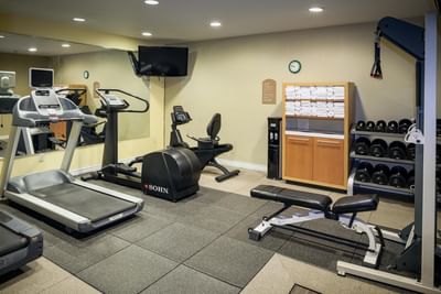Gym area with treadmills in the fitness center of Plaza Inn & Suites at Ashland Creek​