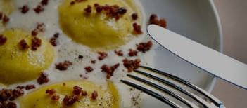 Close-up of an omelet served with a set of cutlery at Da Mariolino Restaurant