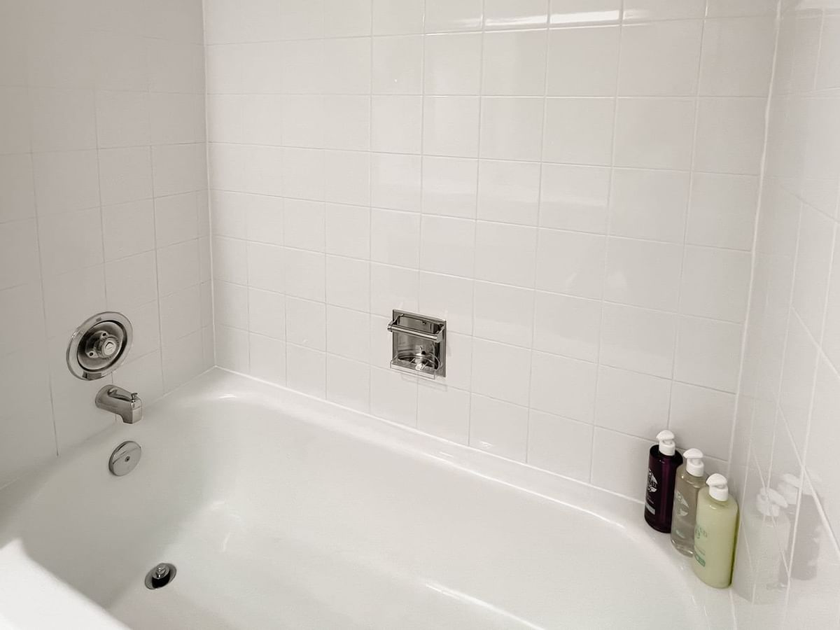 Bath with bottles of shampoos, body washes