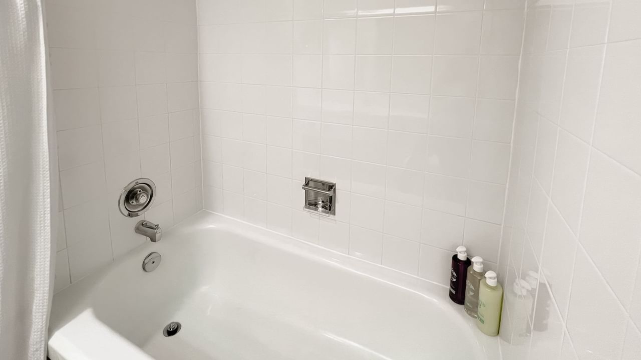 Bath with bottles of shampoos, body washes