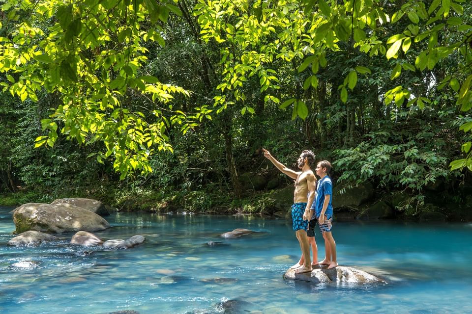 Father & sons on a rock in the River near Hideaway Rio Celeste