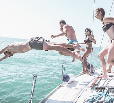 People jumping from a yacht to the sea near Mundo Imperial