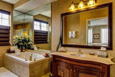 Bathroom vanity and a bathtub in the Presidential Suite at The Wildwood Hotel
