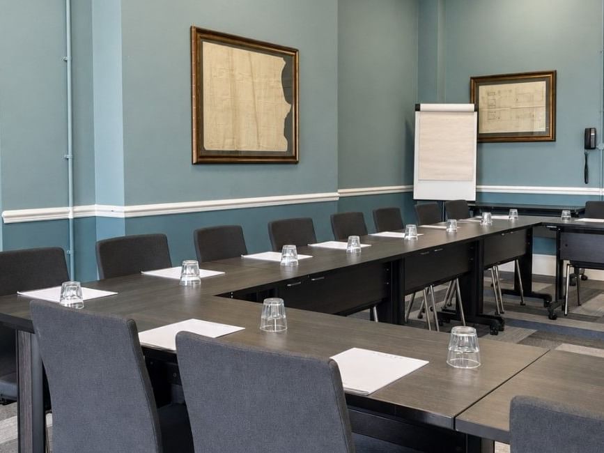 Fairford event room with boardroom-style seating, flipchart, and blue walls at Easthampstead Park Hotel, Bracknell